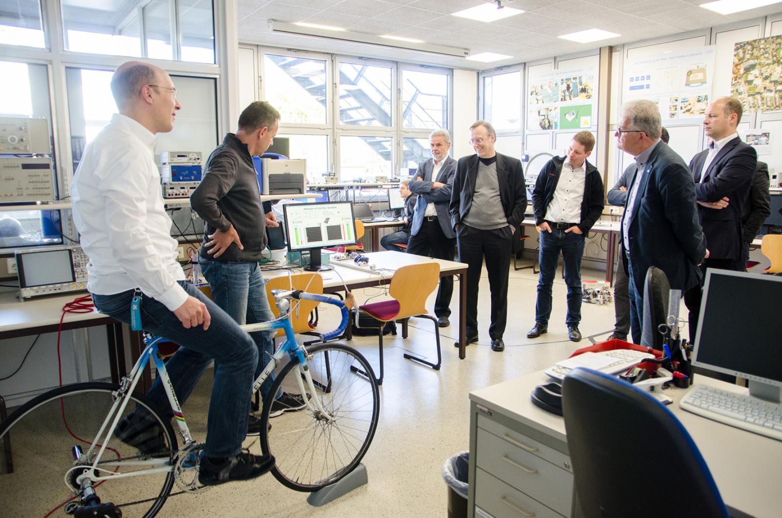 Rauf aufs Rad und strampeln für die Stromerzeugung – das ist Teil der interaktiven Lehre an unserer Hochschule, die sich die NRW-Elektrotechnik-Dekane und -Prodekane auf dem Steinfurter Campus ansahen. (Foto: FH Münster/Theresa Gerks)